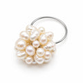 A silver ring featuring a cluster of irregular, lustrous cream-colored freshwater pearls on a plain white background.